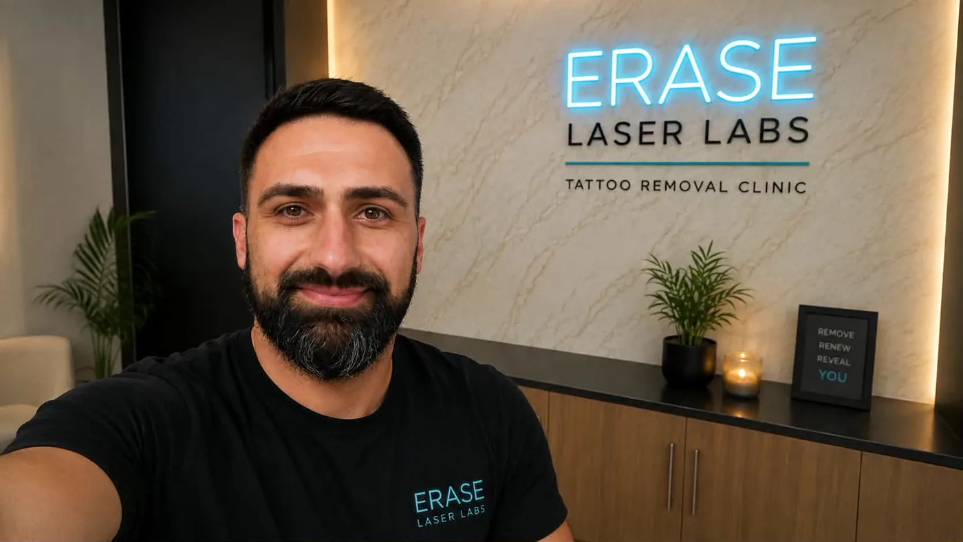 Ako, founder of Erase Laser Labs, in front of the studio's neon sign